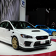A Subaru WRX STI S209 on display next to an Impreza 22B at the Detroit Auto Show in January 2019.